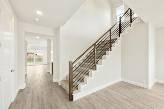 stairs featuring recessed lighting, baseboards, and wood finished floors