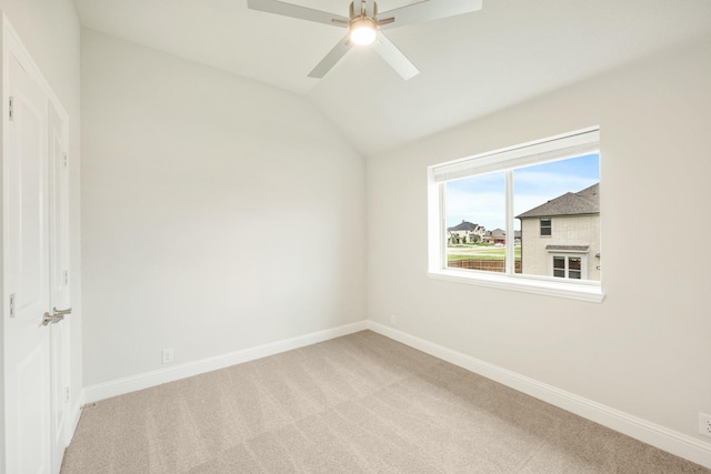 unfurnished bedroom featuring carpet flooring, baseboards, and vaulted ceiling