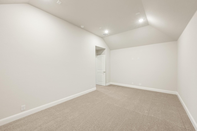 bonus room featuring baseboards, recessed lighting, vaulted ceiling, and light carpet