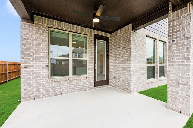 view of patio featuring ceiling fan and fence