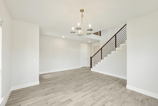 interior space featuring an inviting chandelier, recessed lighting, light wood-type flooring, and stairs