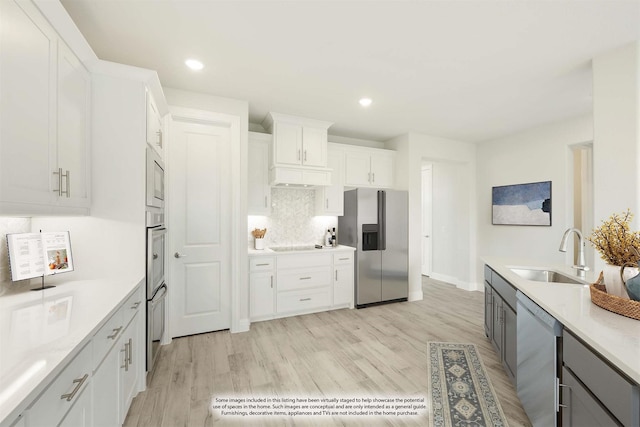 4601 Nomad Dr, Midlothian, TX 76065 - kitchen with a sink, appliances with stainless steel finishes, tasteful backsplash, light wood-style flooring, and recessed lighting