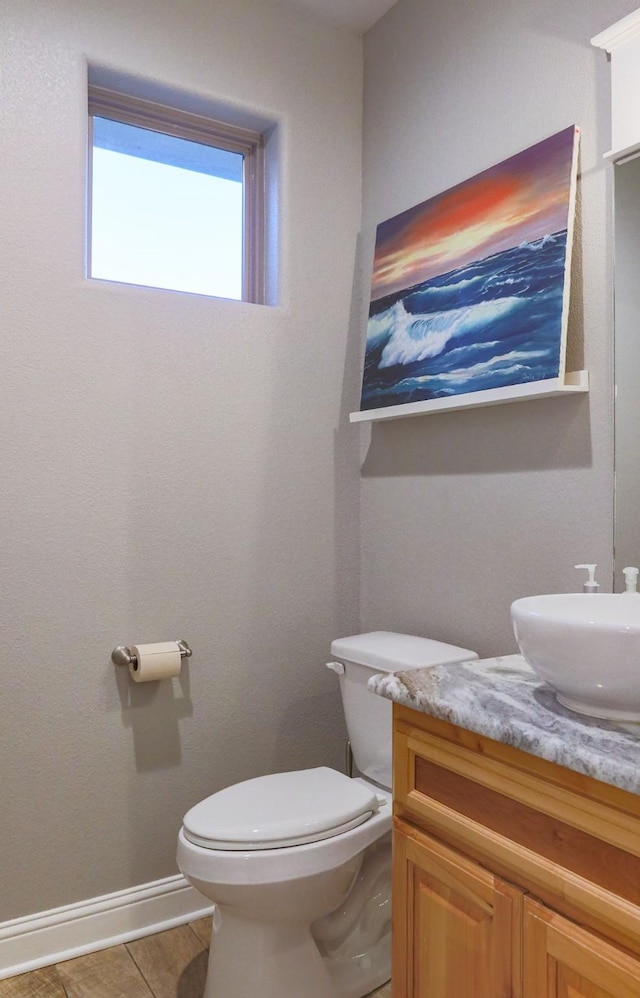 bathroom with toilet, tile patterned flooring, and vanity