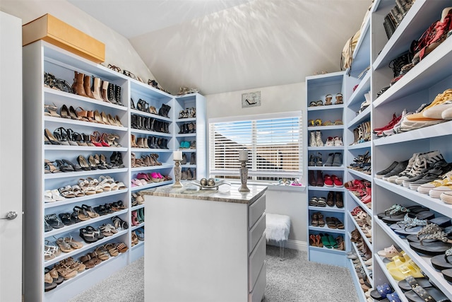 spacious closet with carpet flooring and lofted ceiling