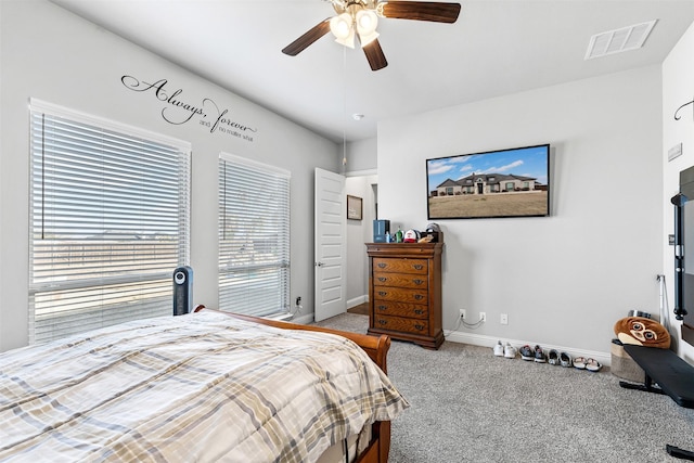 carpeted bedroom featuring ceiling fan, visible vents, and baseboards