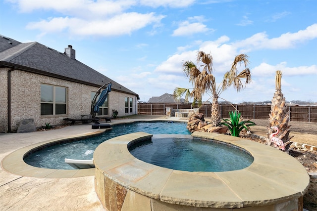 view of pool featuring an in ground hot tub