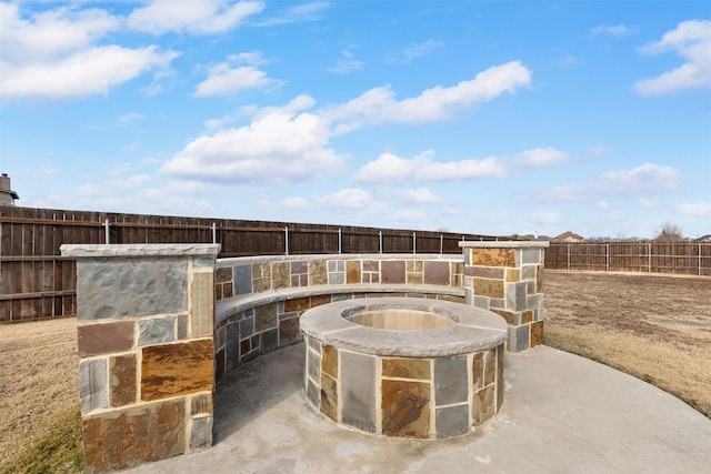 view of patio / terrace featuring an outdoor fire pit and fence