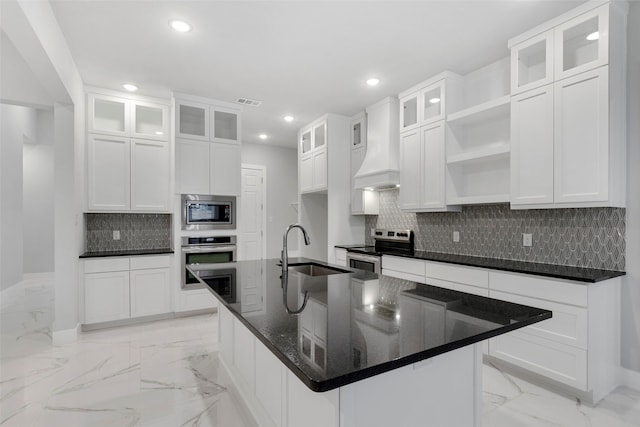 kitchen with sink, white cabinets, custom range hood, and appliances with stainless steel finishes