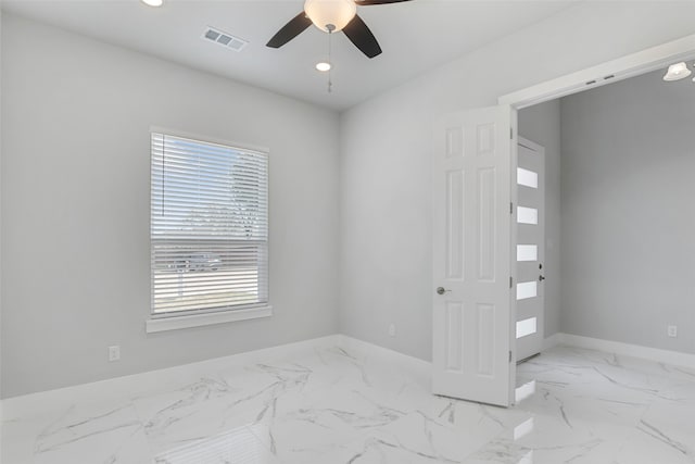 spare room with ceiling fan