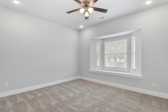 spare room with light carpet and ceiling fan