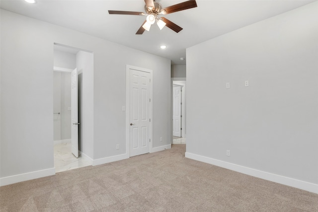 unfurnished bedroom with ceiling fan and light colored carpet