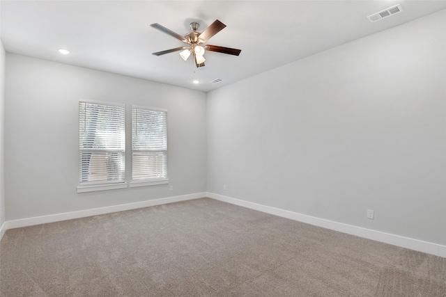 empty room with ceiling fan and carpet flooring