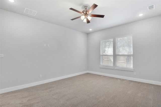 carpeted spare room featuring ceiling fan