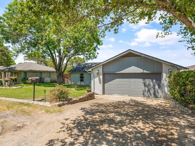 ranch-style house with a front yard and a garage