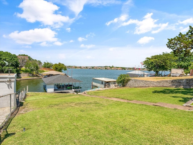 dock area featuring a lawn and a water view