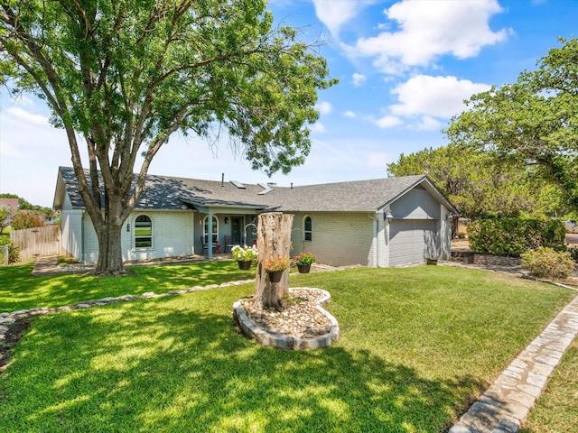 single story home featuring a garage and a front lawn