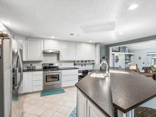 kitchen with sink, white cabinets, light tile patterned floors, and appliances with stainless steel finishes