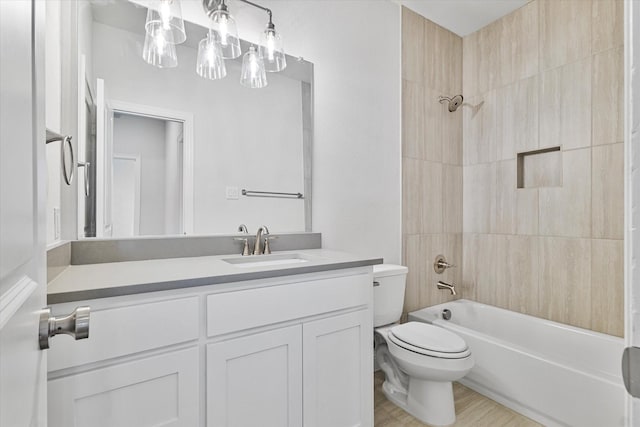 full bathroom with hardwood / wood-style flooring, toilet, vanity, and shower / washtub combination