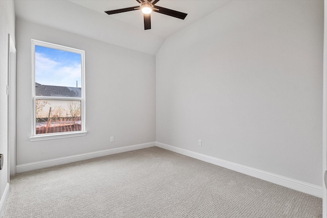 empty room featuring vaulted ceiling, carpet flooring, and ceiling fan