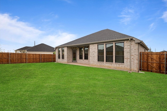 rear view of house featuring a lawn