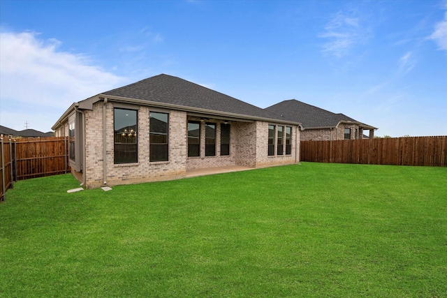 rear view of house with a yard