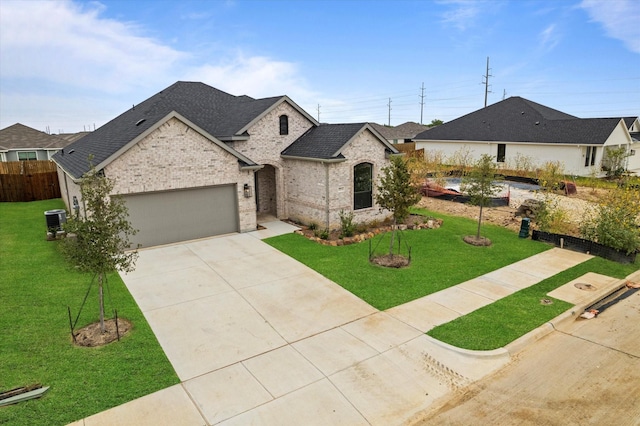 view of front of house with a garage, central air condition unit, and a front lawn