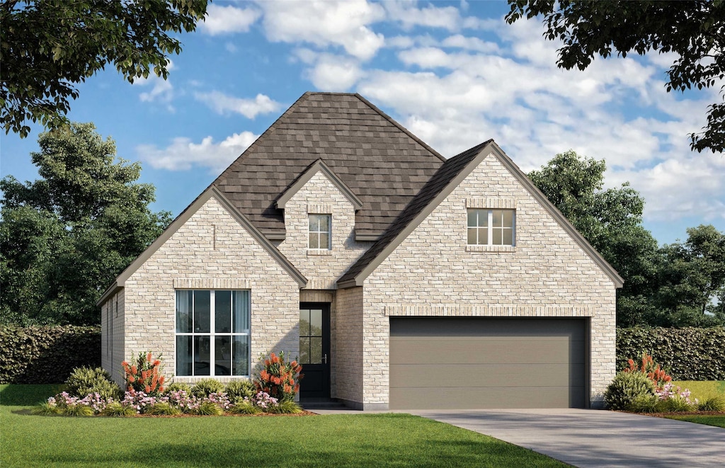 view of front of property with a garage and a front lawn