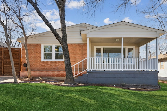 view of front of house with a porch and a front lawn