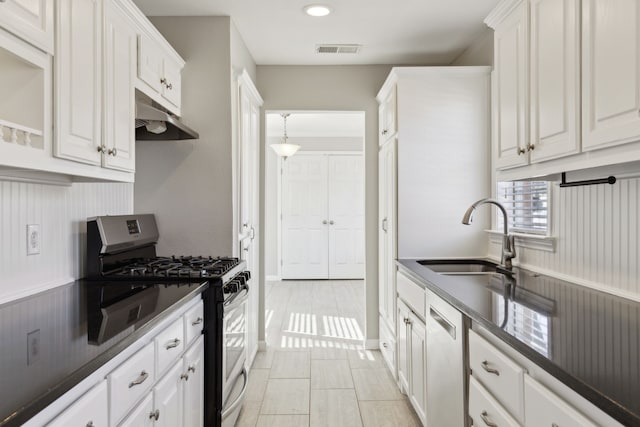 kitchen featuring white cabinetry, sink, light tile patterned floors, and stainless steel appliances