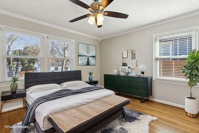 bedroom with ornamental molding, ceiling fan, and light wood-type flooring