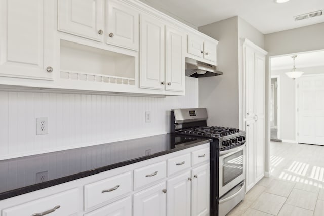 kitchen featuring light tile patterned flooring, stainless steel range with gas cooktop, and white cabinets