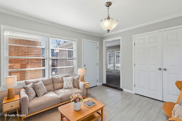 living room featuring crown molding, a wealth of natural light, and light hardwood / wood-style floors