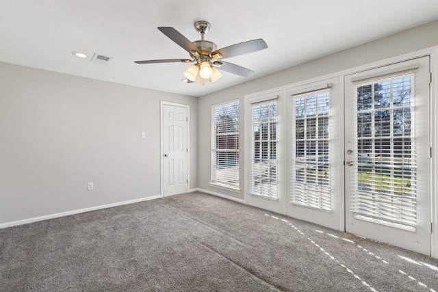 spare room with ceiling fan and carpet