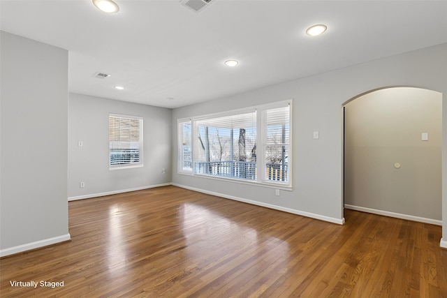 spare room featuring wood-type flooring