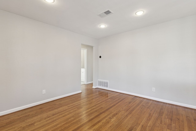 spare room with hardwood / wood-style floors