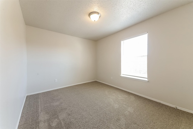 carpeted spare room with a textured ceiling