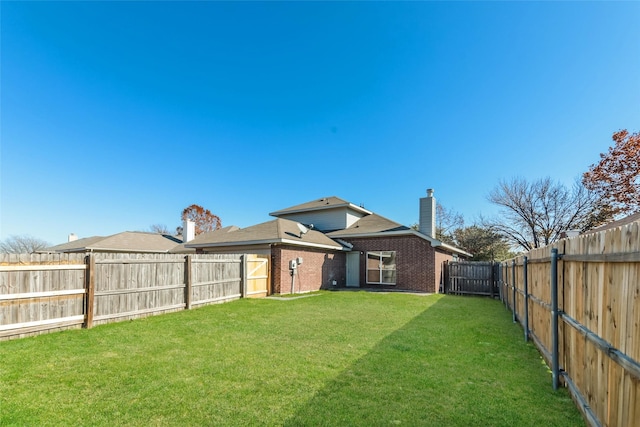 rear view of house featuring a lawn