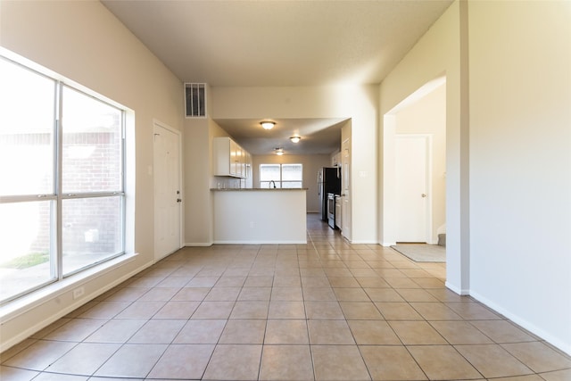 unfurnished living room with light tile patterned floors