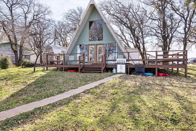 back of house with a deck and a yard