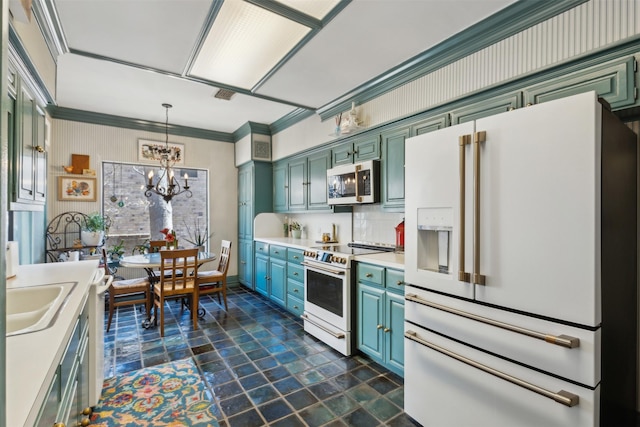 kitchen featuring decorative light fixtures, light countertops, green cabinets, a sink, and white appliances