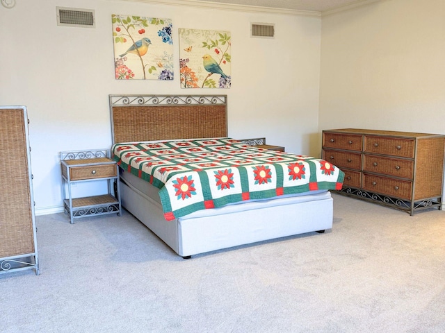 carpeted bedroom with ornamental molding and visible vents