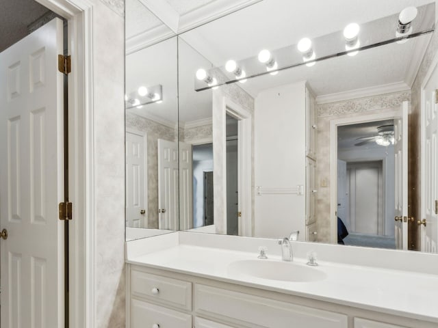 ensuite bathroom featuring crown molding, vanity, and ensuite bath