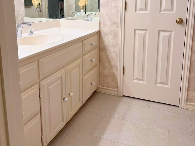 bathroom featuring tile patterned flooring and vanity