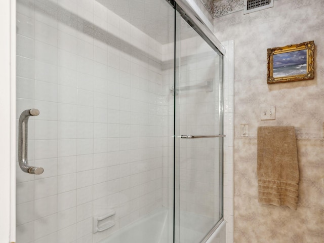 bathroom featuring visible vents and combined bath / shower with glass door