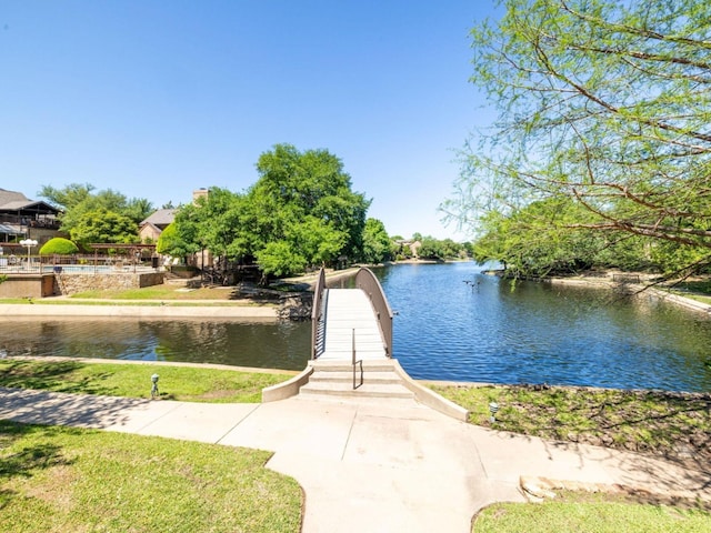 view of dock featuring a yard and a water view