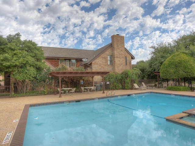 pool with fence, a pergola, and a patio