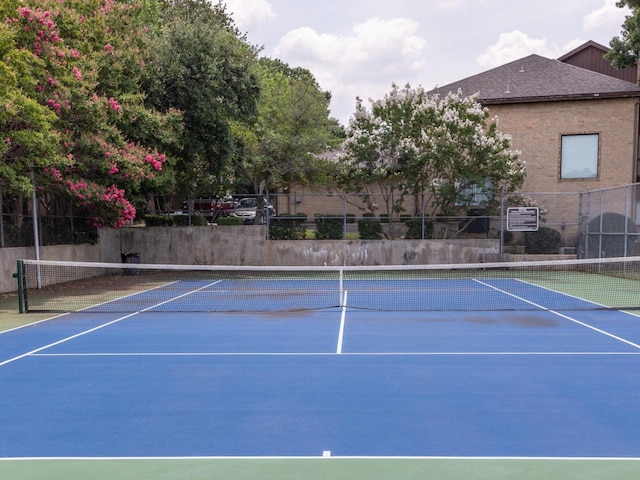 view of tennis court featuring fence