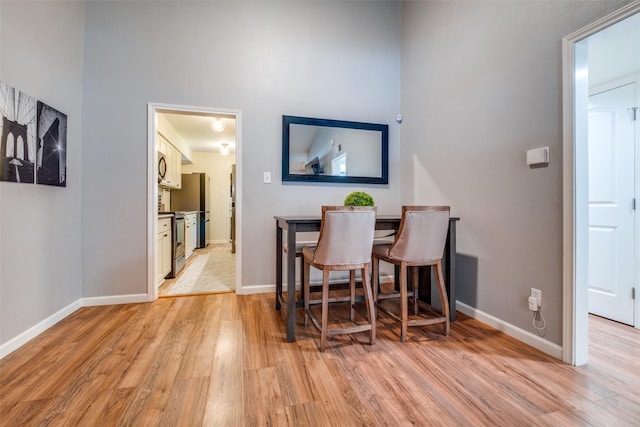 dining space with light wood-type flooring