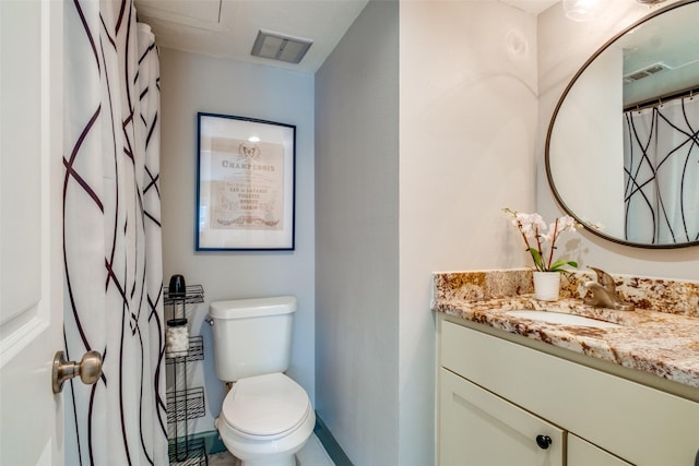 bathroom with toilet and vanity