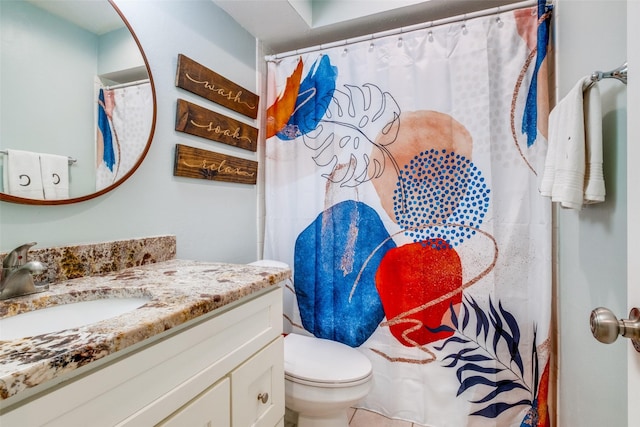 bathroom featuring toilet and vanity